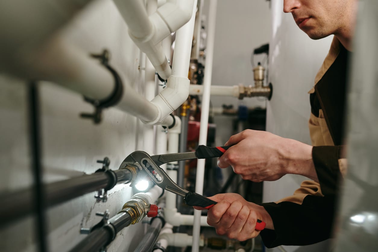 Plumbers maintaining commercial plumbing pipes in Castle Rock
