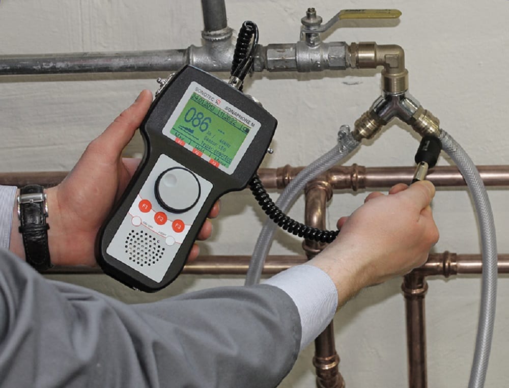 Plumber testing pipes with electronic leak detection equipment in Castle Rock