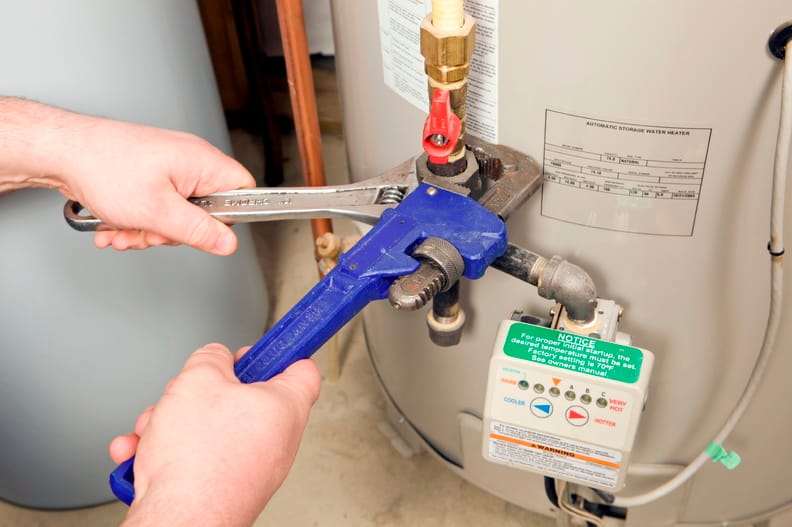 Plumber repairing a water heater valve in Castle Rock